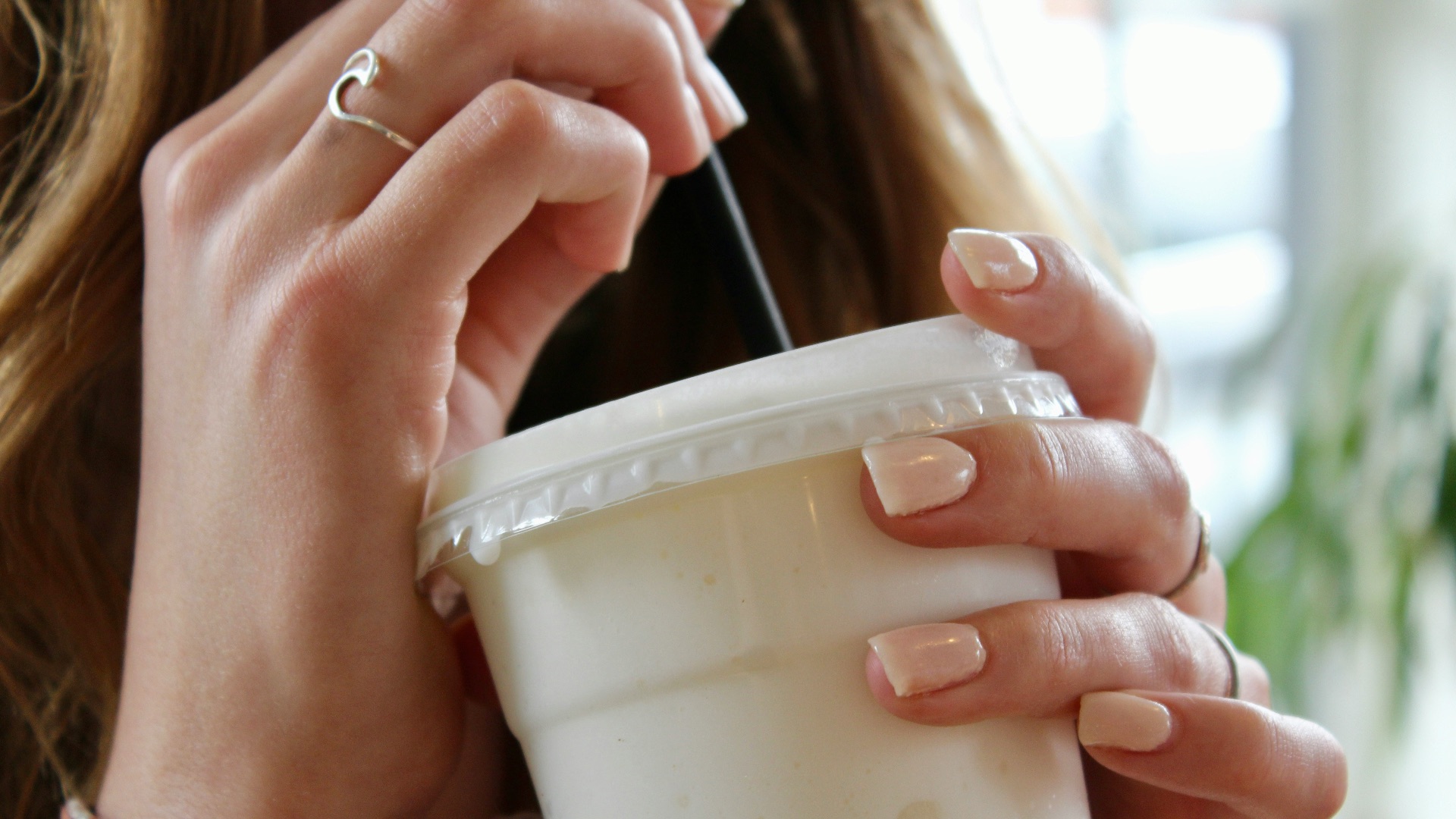 person holding white plastic cup