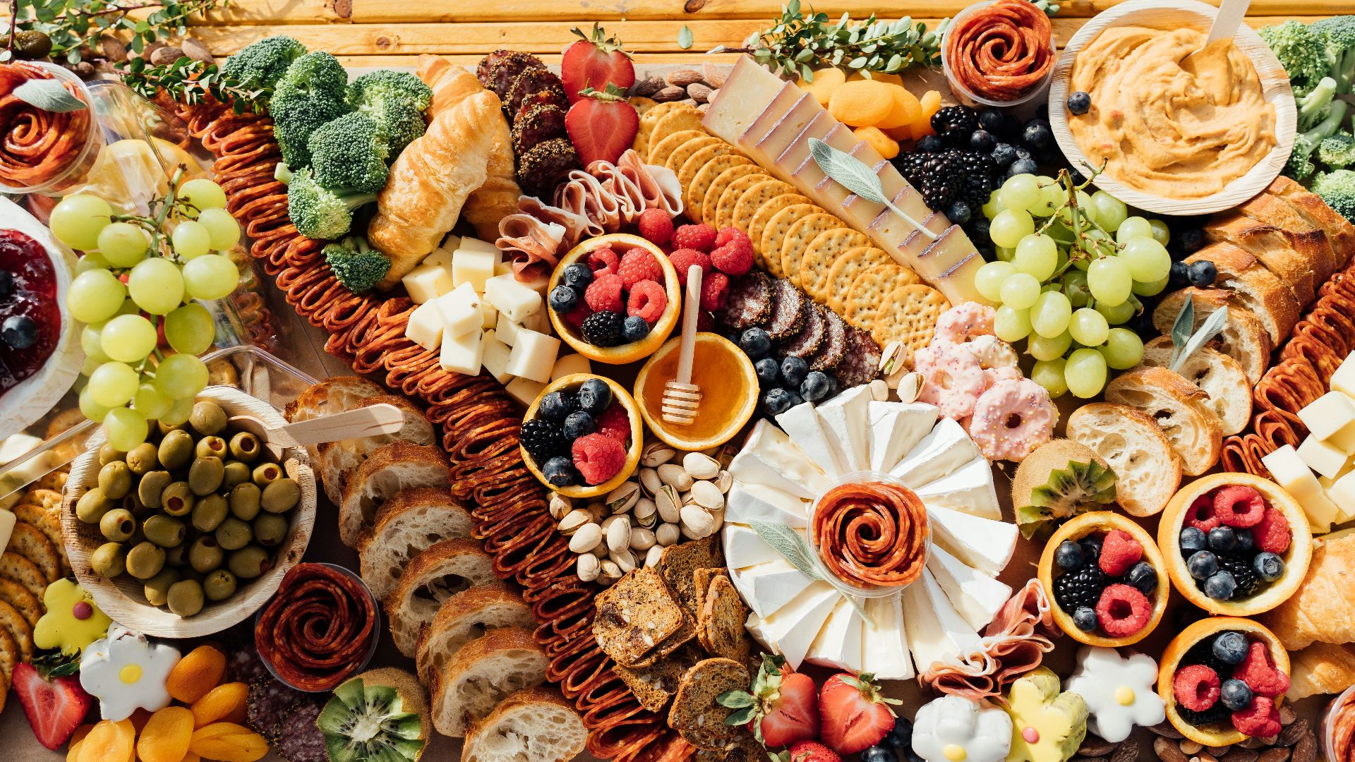 a wooden table topped with lots of different types of food