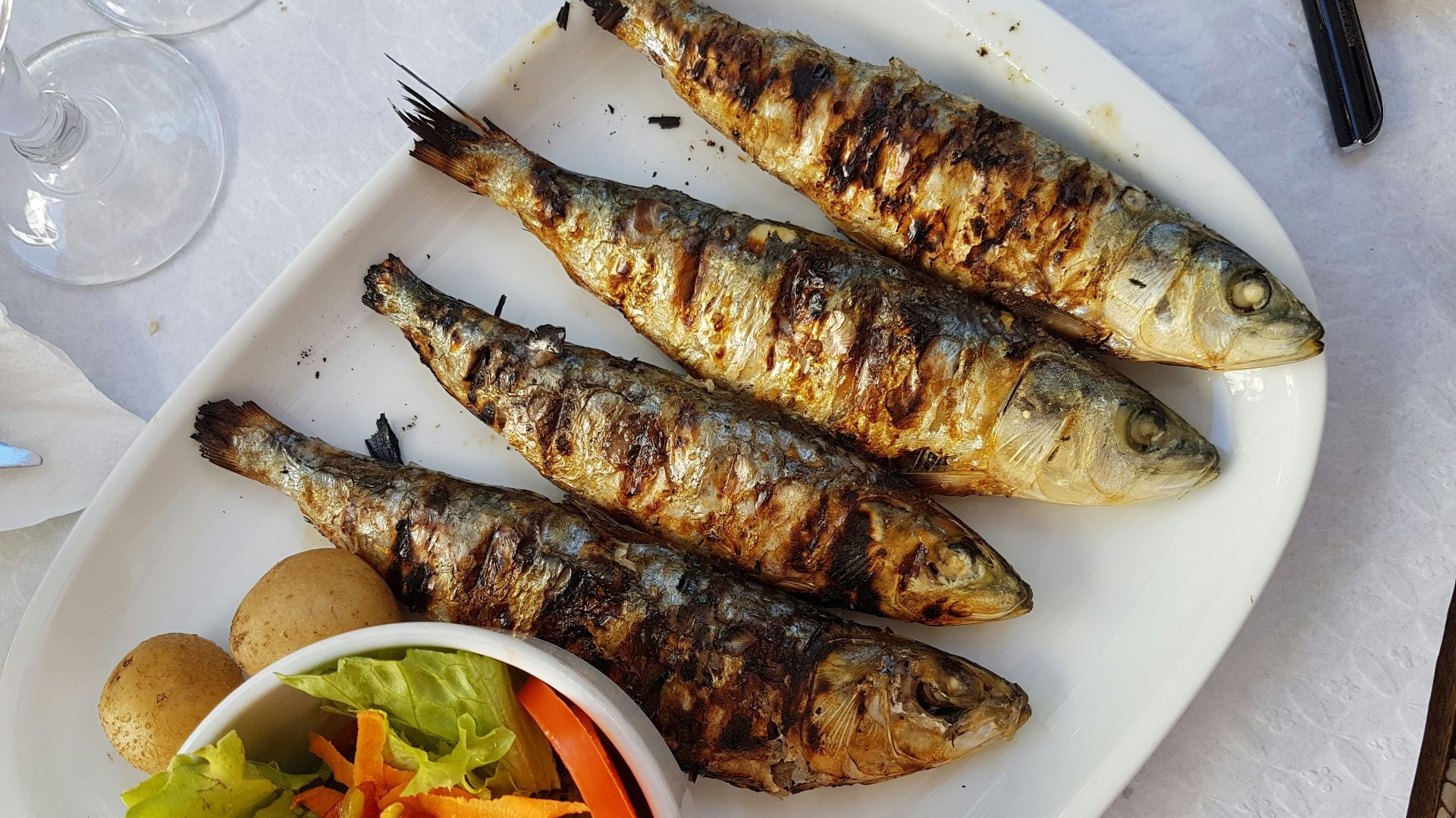 grilled fish with vegetable salad on white ceramic plate