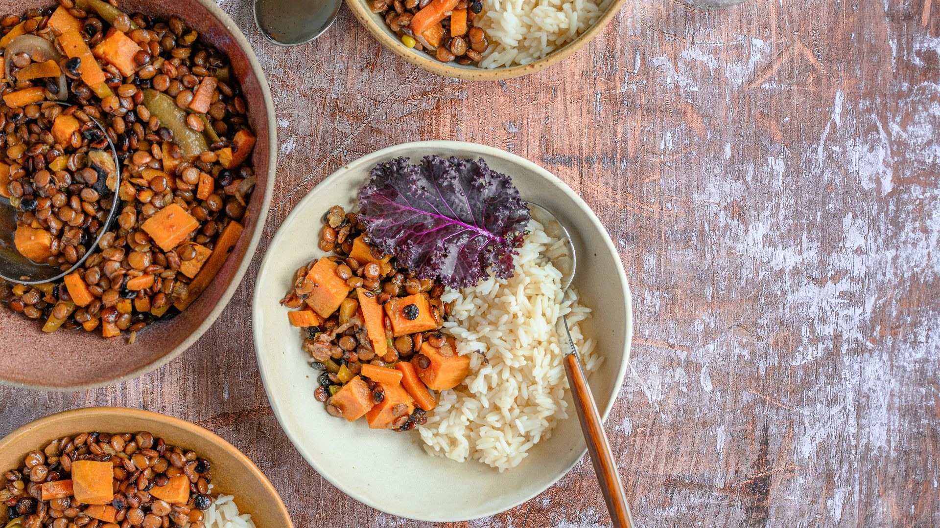 three bowls of food on a wooden table