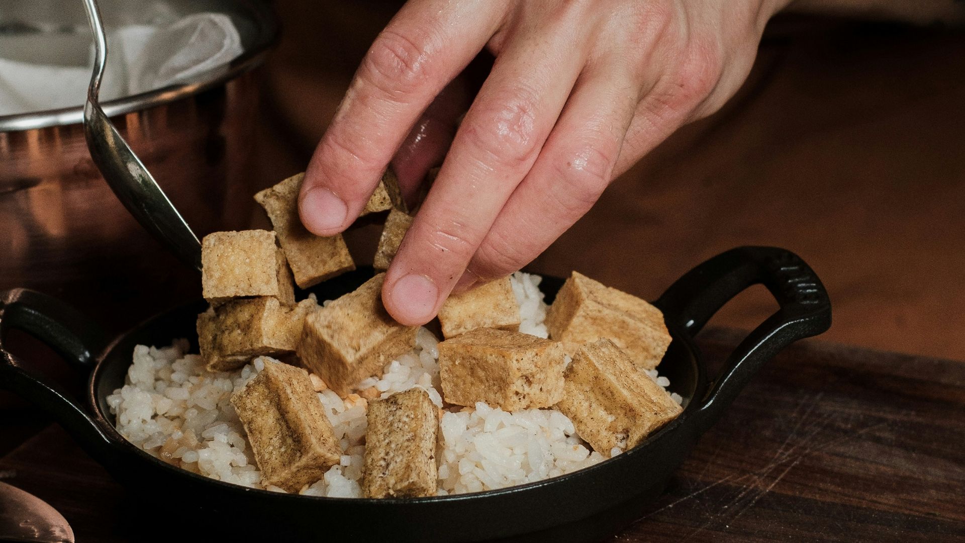 a person is putting some food in a bowl