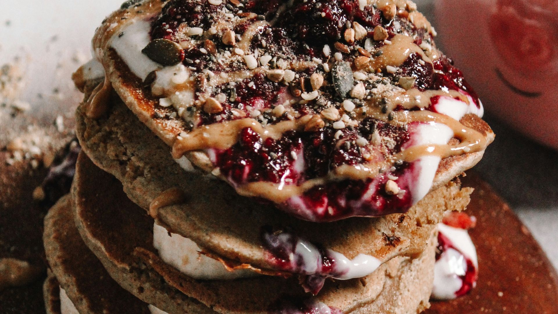 chocolate cupcake with white icing on brown wooden table