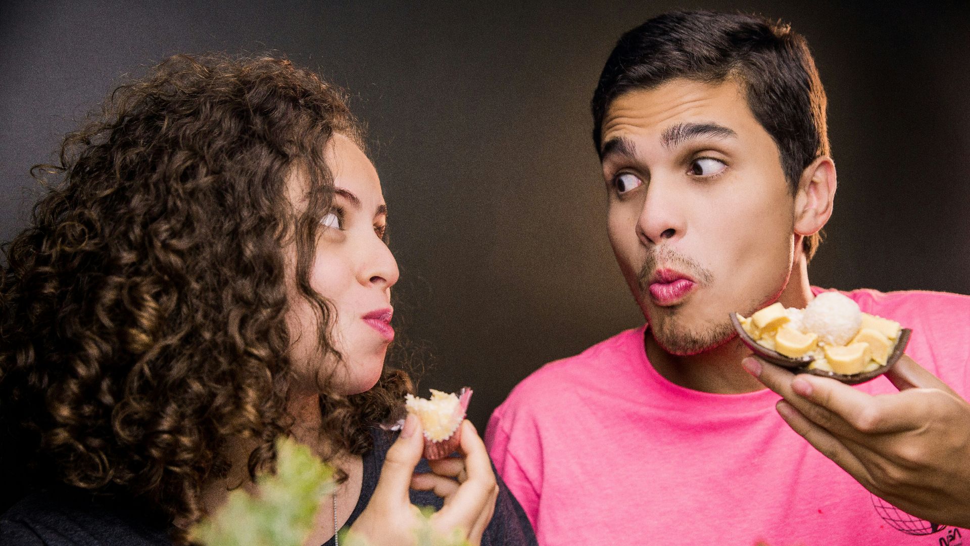 woman in pink crew neck shirt beside man in yellow crew neck shirt
