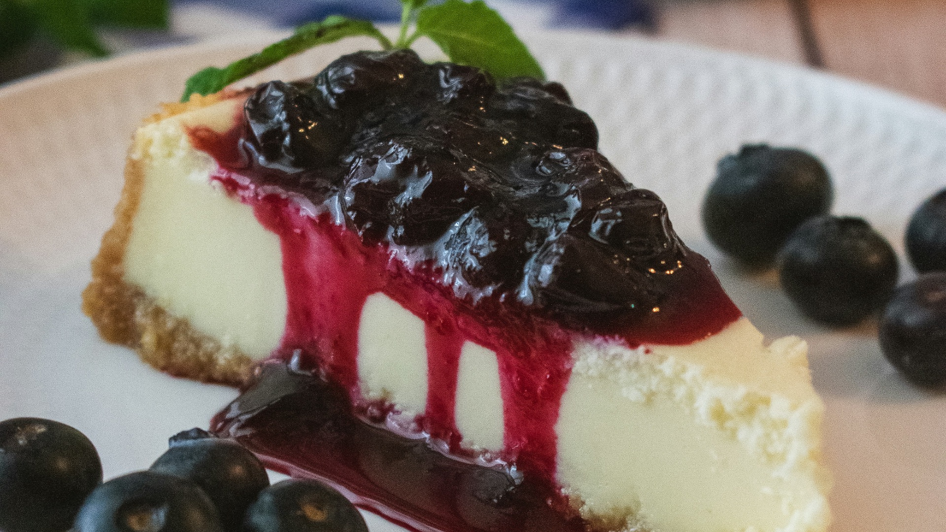 a piece of cheesecake with blueberries on a plate