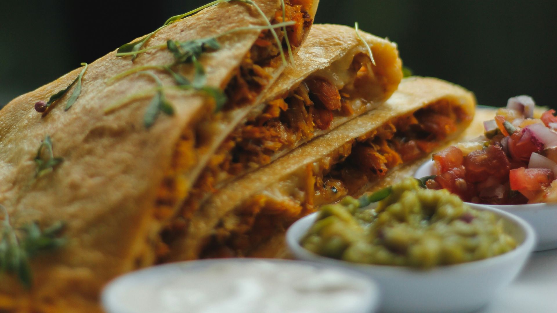 a plate topped with a quesadilla cut in half