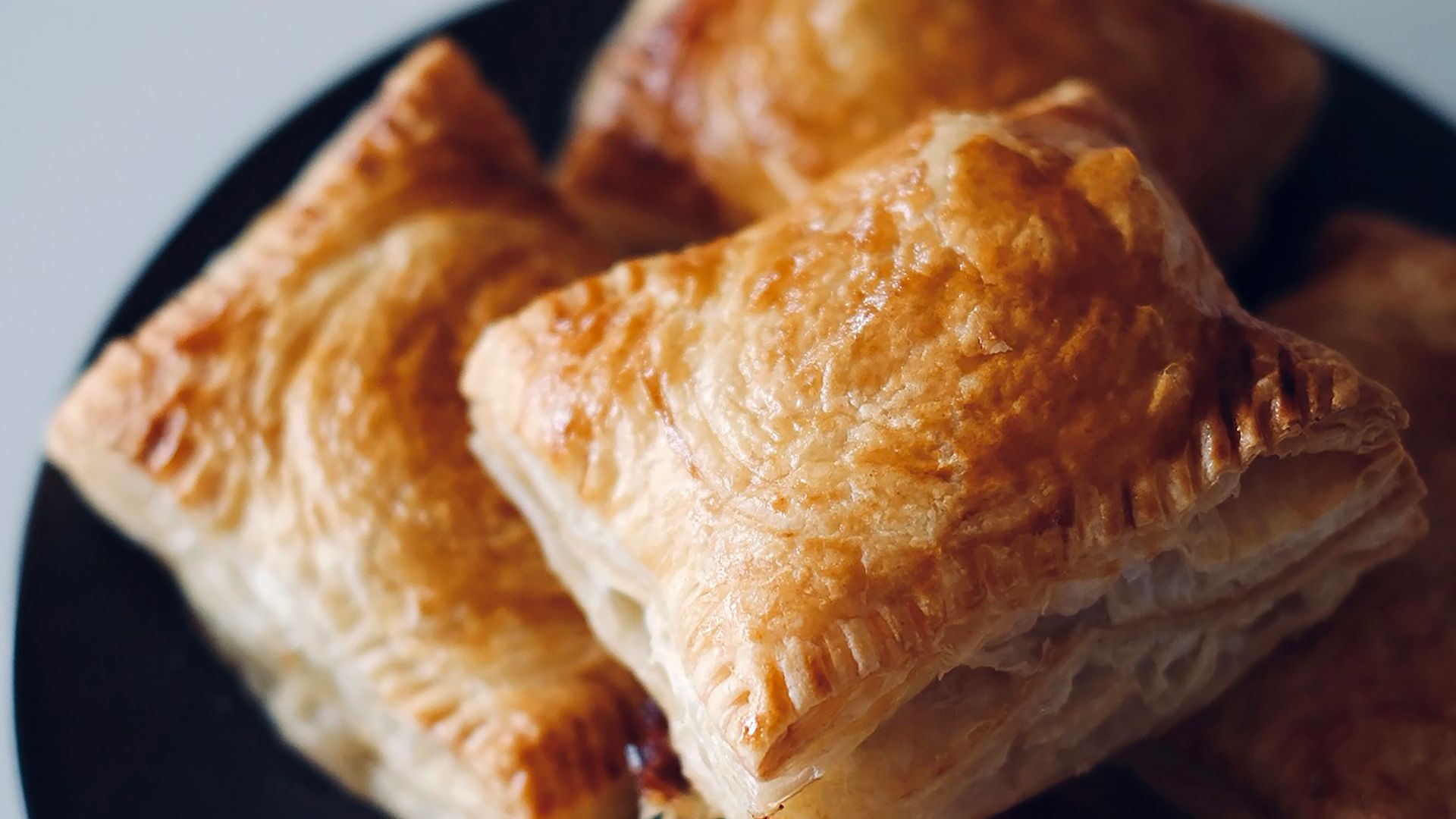 a black plate topped with pastries on top of a table