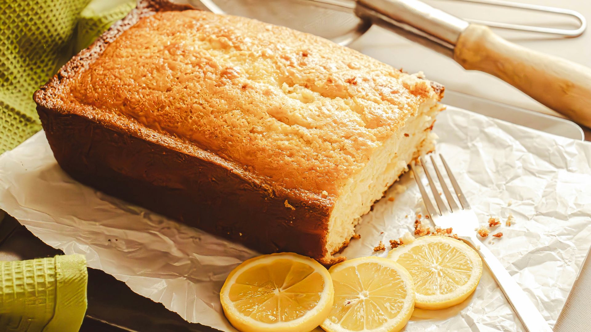 a loaf of lemon bread sitting on top of a piece of wax paper