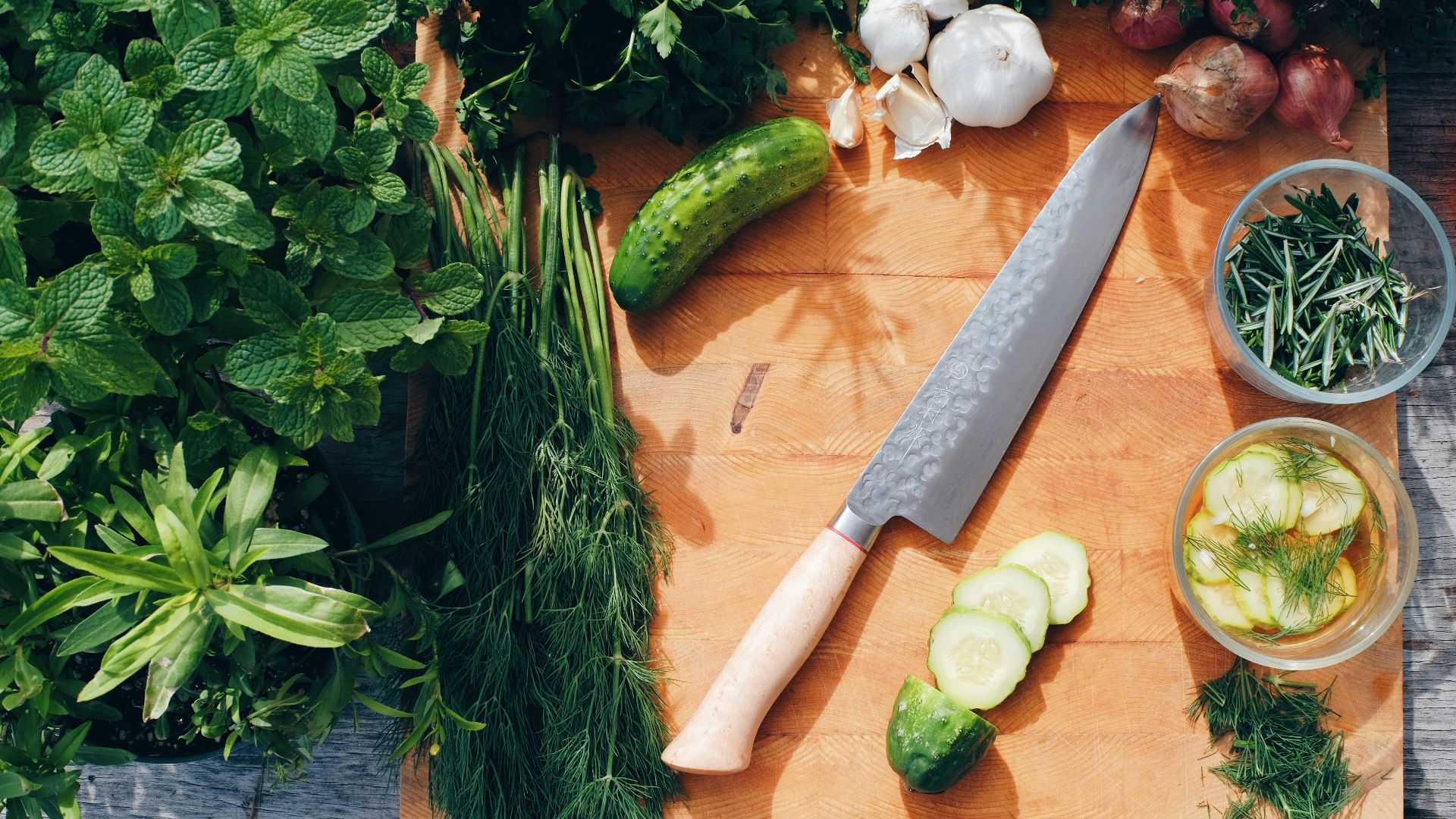 sliced cucumber and green vegetable on brown wooden chopping board