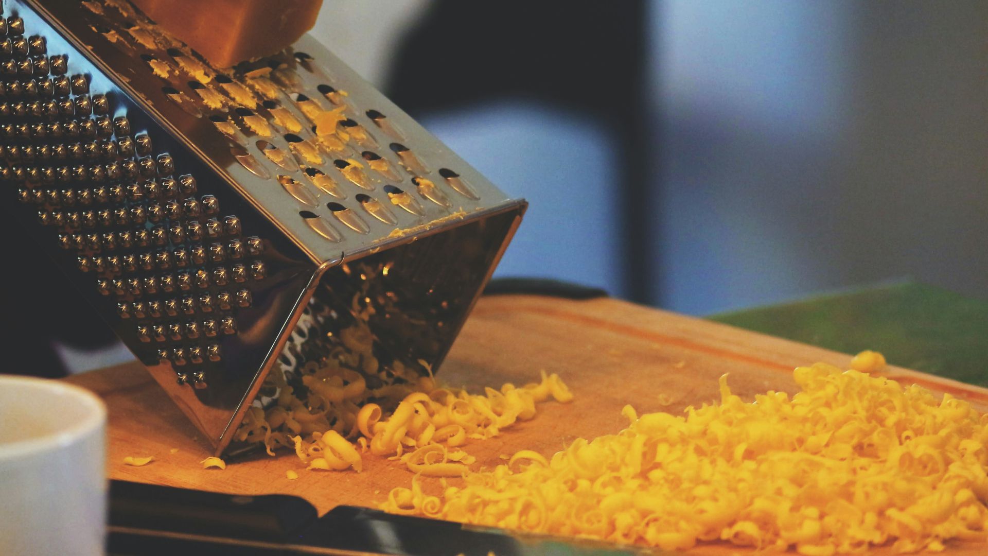 person grating cheese