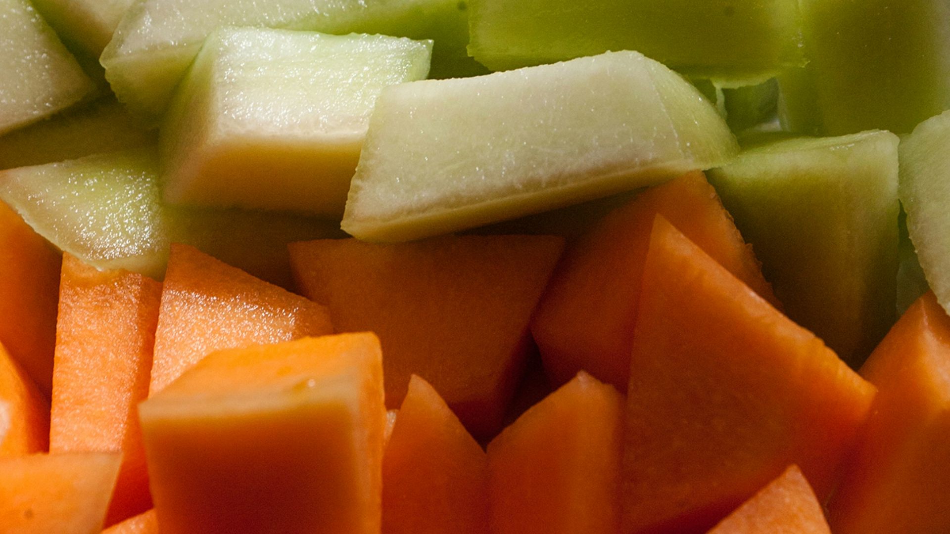 a close up of a plate of cut up fruit