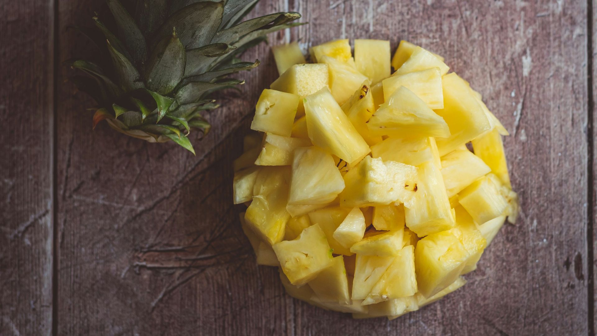 yellow rose on brown wooden table