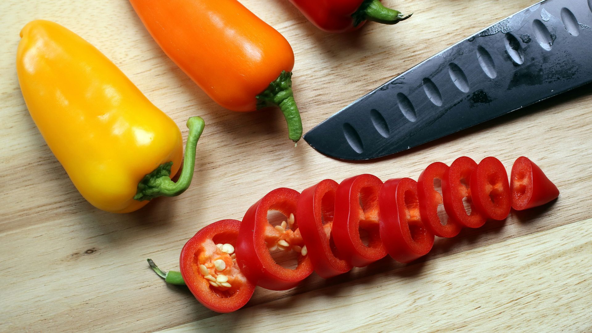 sliced red bell peppers on chopping board