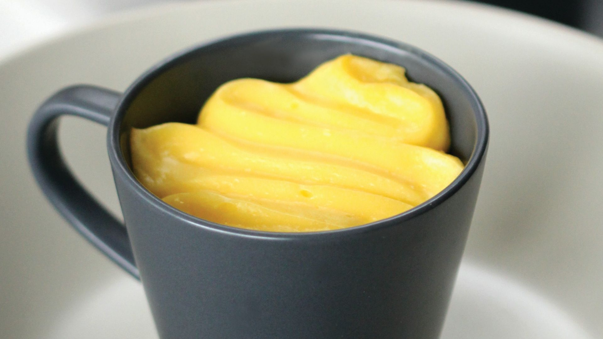 yellow ceramic mug on white ceramic plate