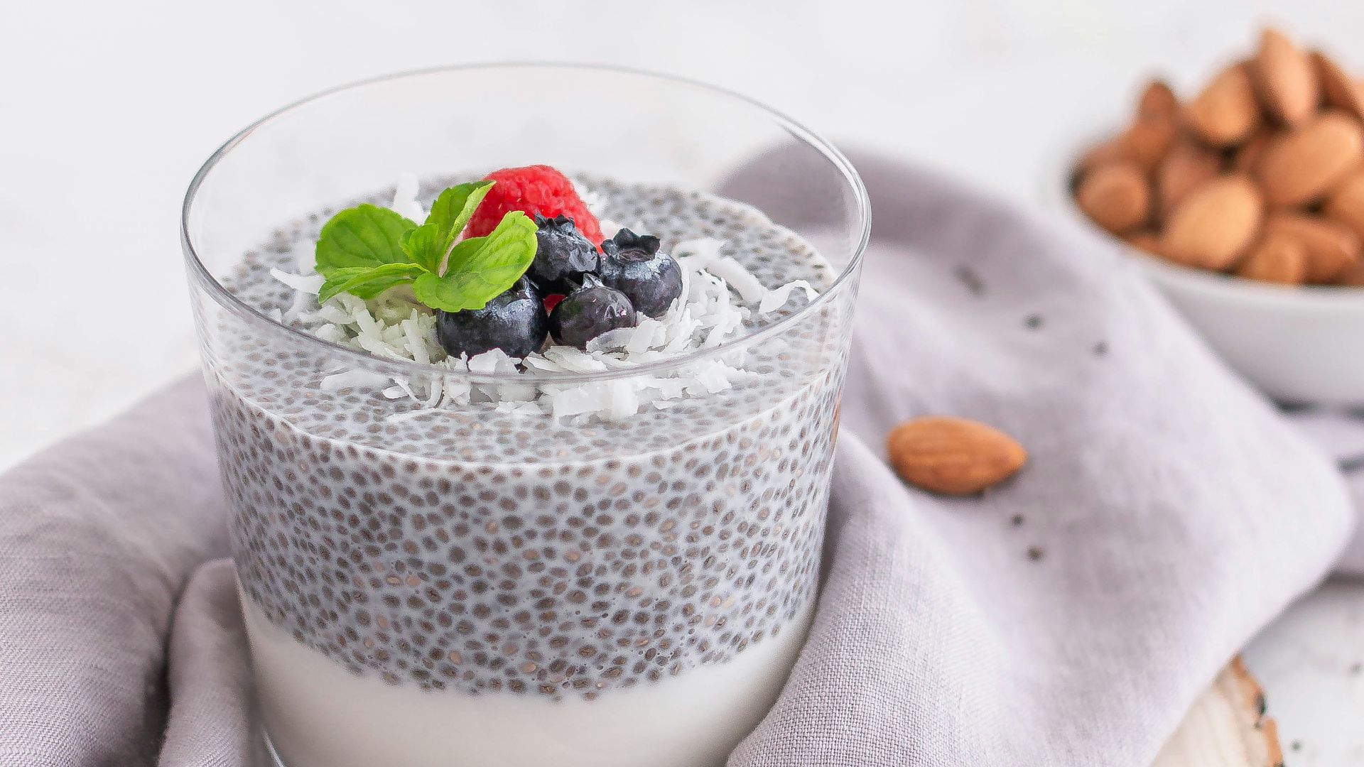 a glass of milk with berries and a spoon
