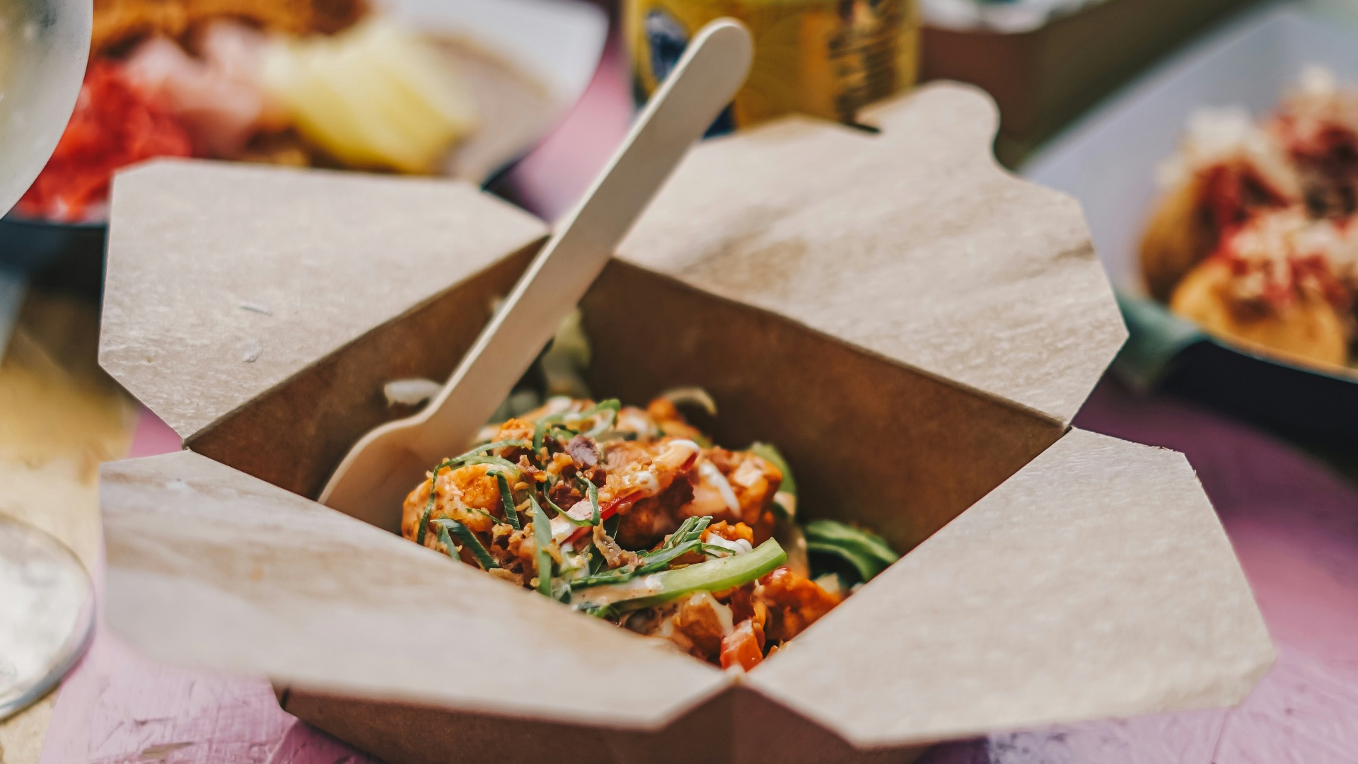 a table topped with boxes of food and drinks