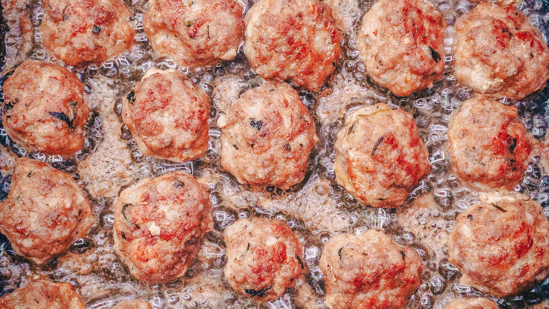 a pan filled with meatballs covered in sauce