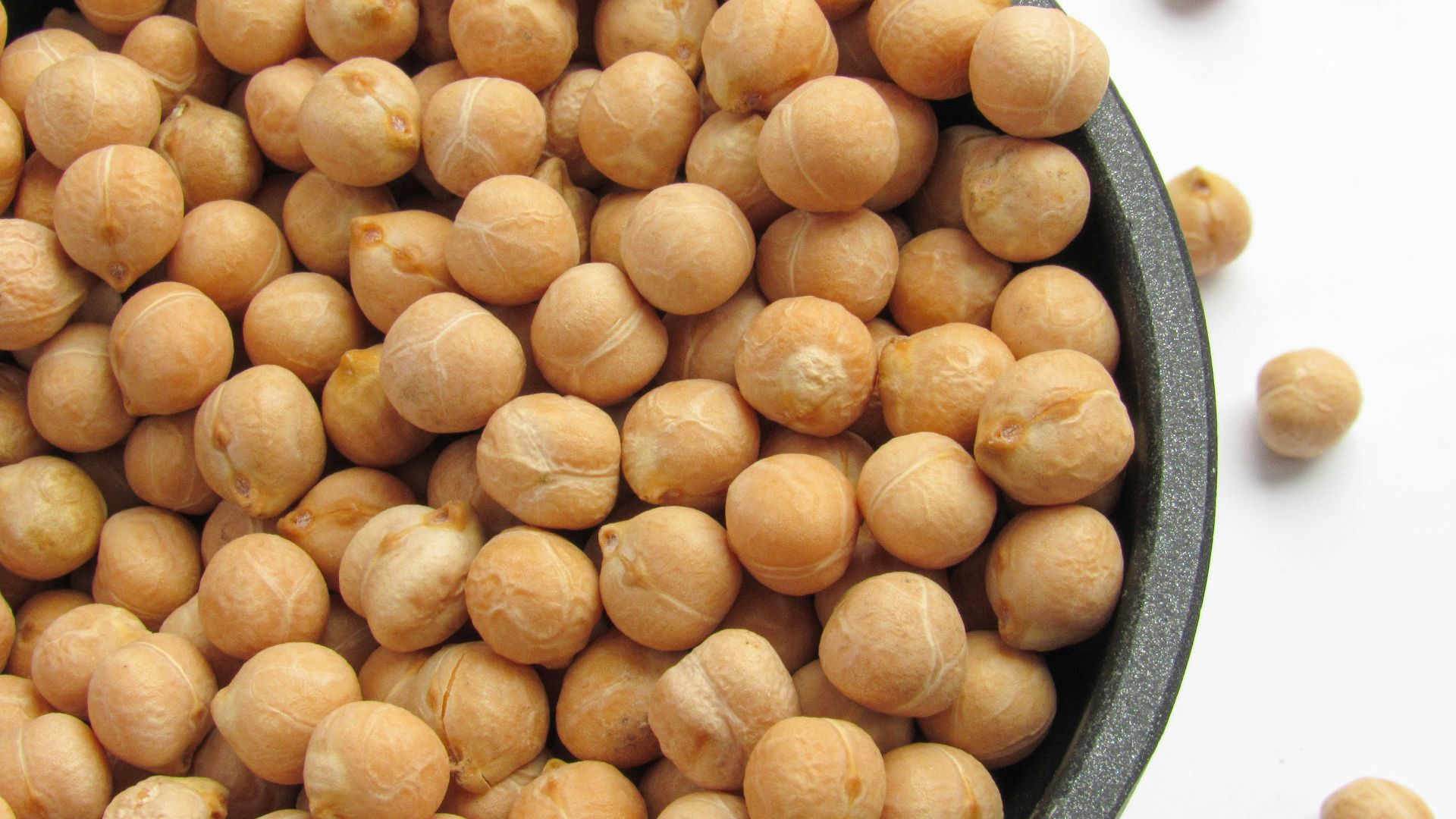 a bowl filled with chickpeas sitting on top of a table