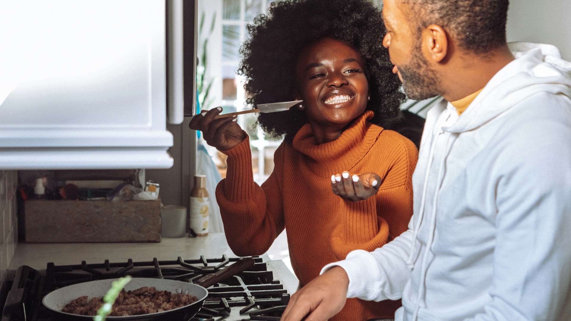man in white dress shirt holding a woman in brown long sleeve shirt