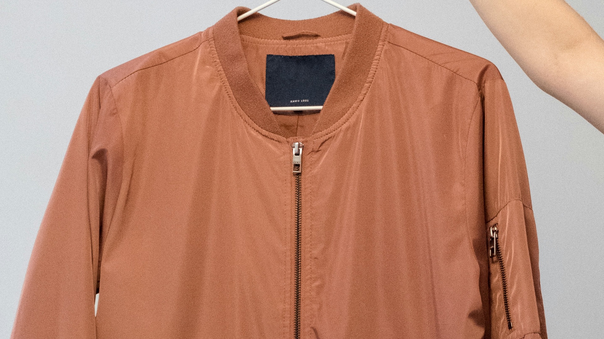 brown long sleeve shirt on white clothes hanger