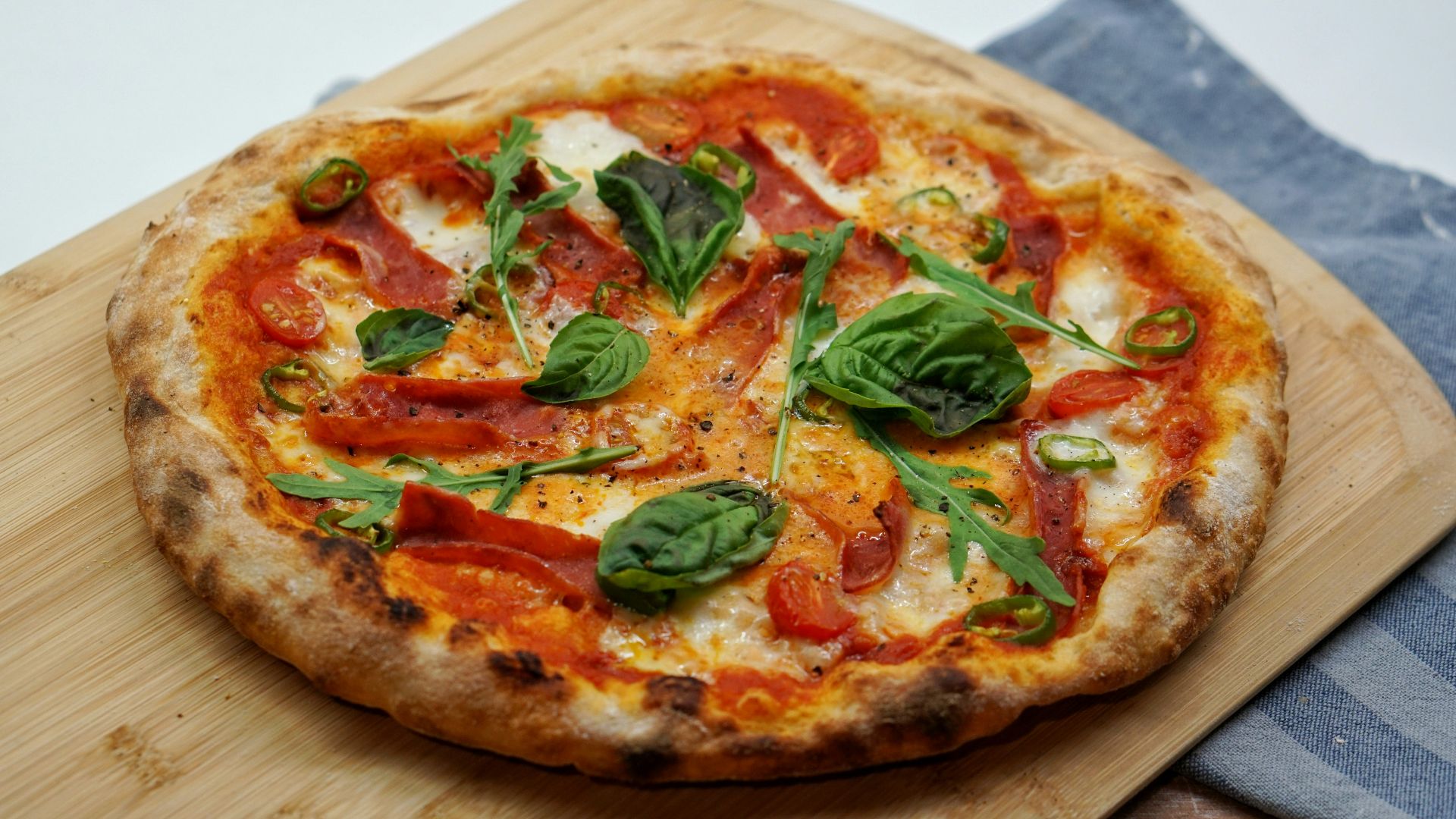 pizza with green leaves and red sauce
