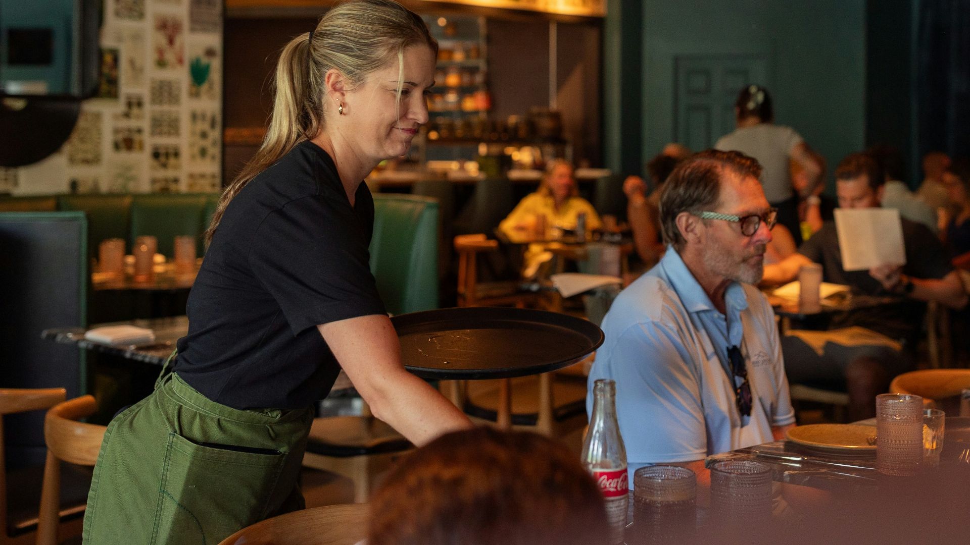 A group of people sitting at tables in a restaurant