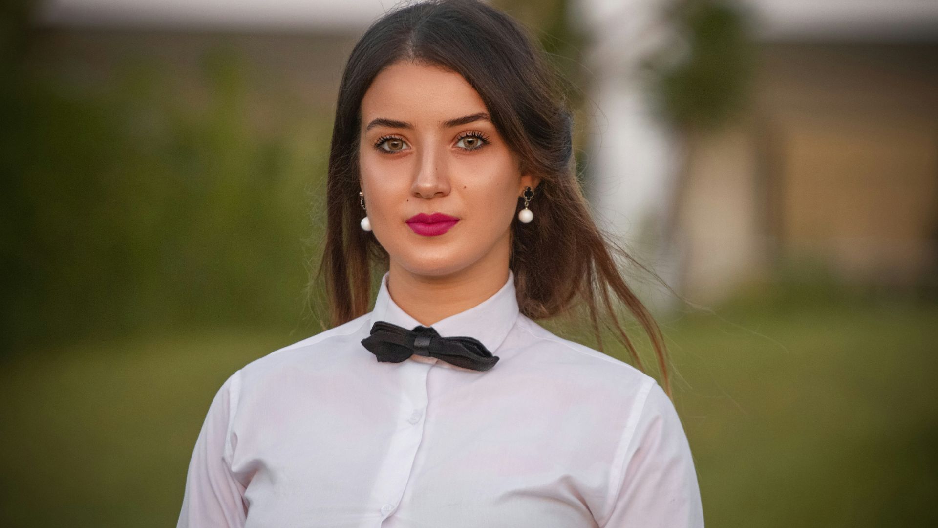 woman in white dress shirt and black bowtie