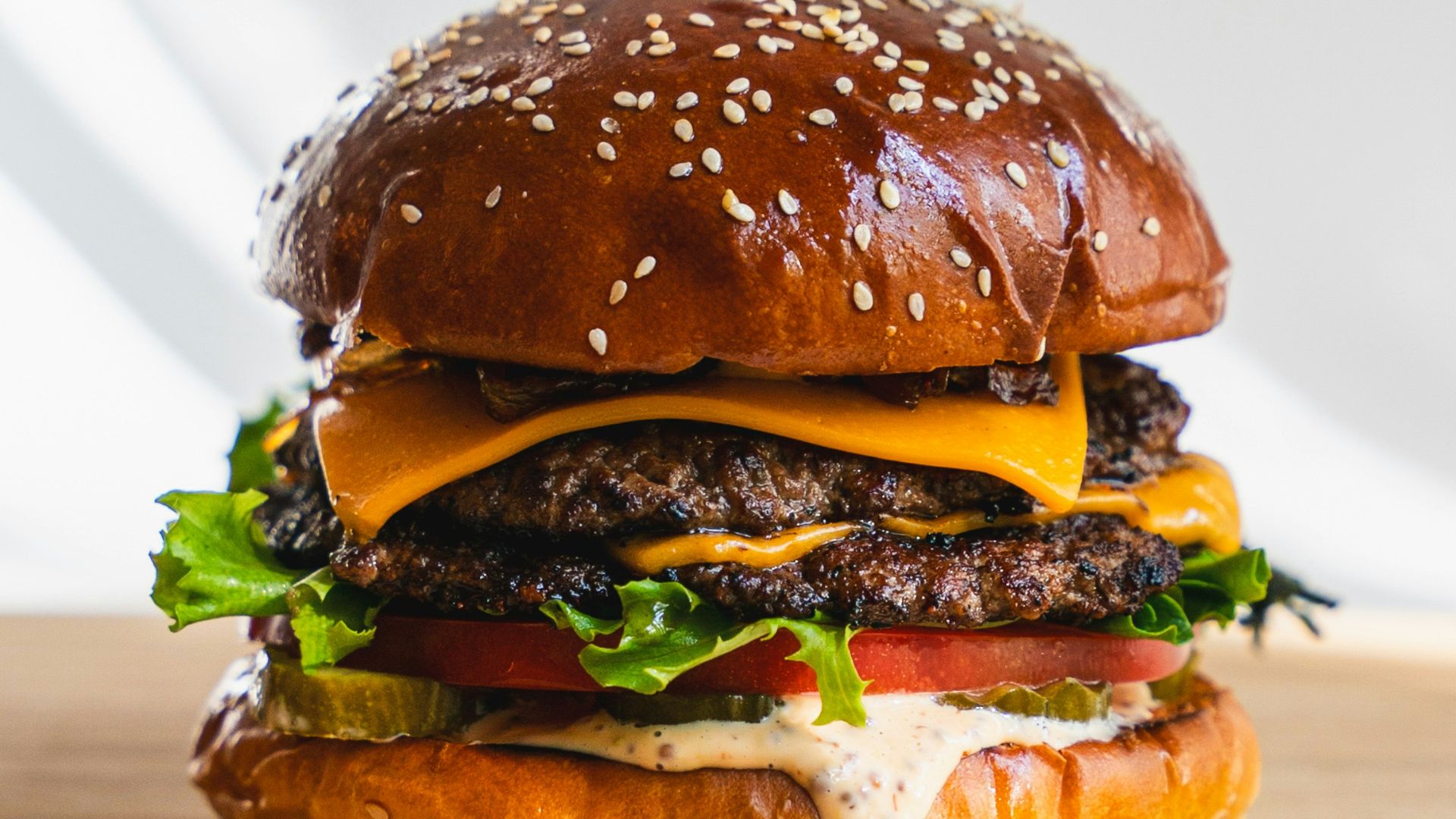 a hamburger sitting on top of a wooden cutting board