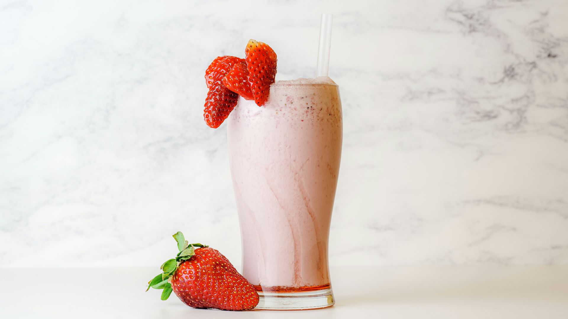 strawberry shake in clear drinking glass