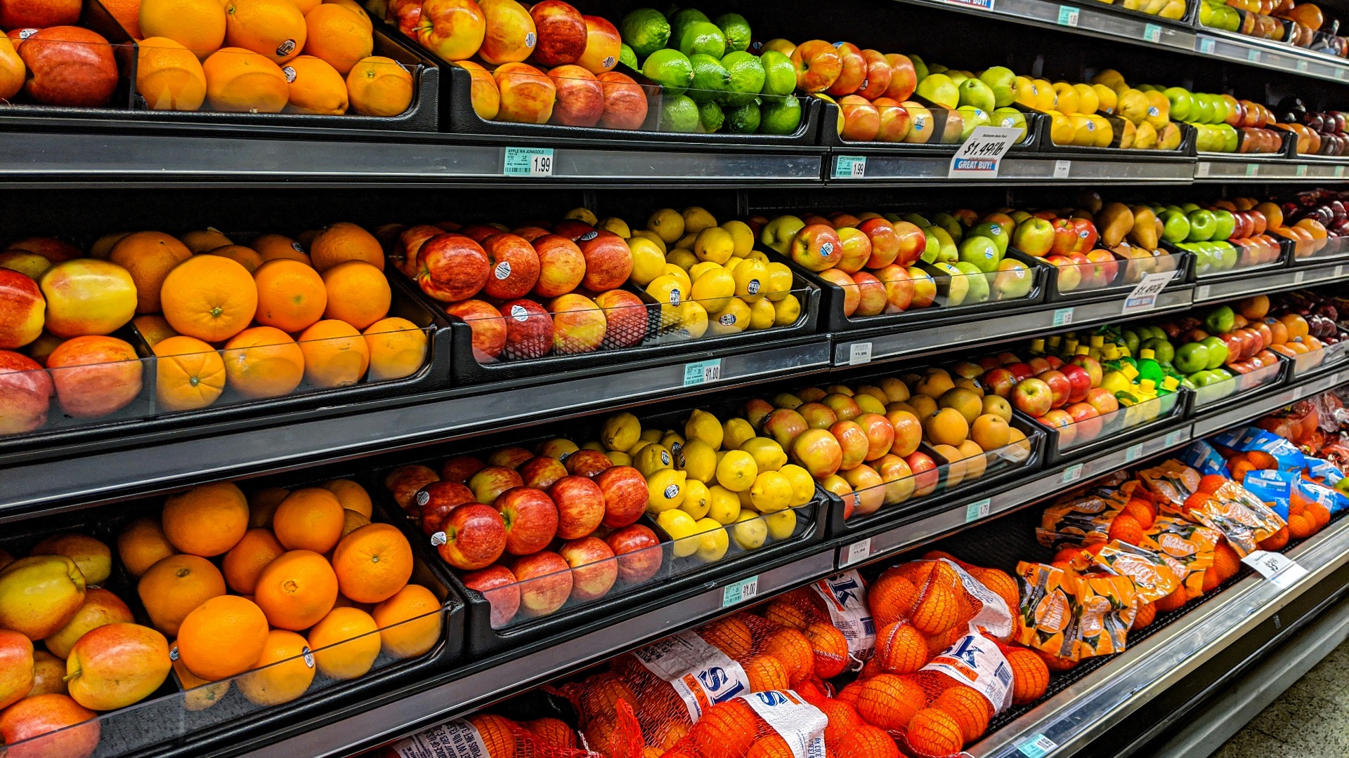 yellow and red apples on black plastic crate