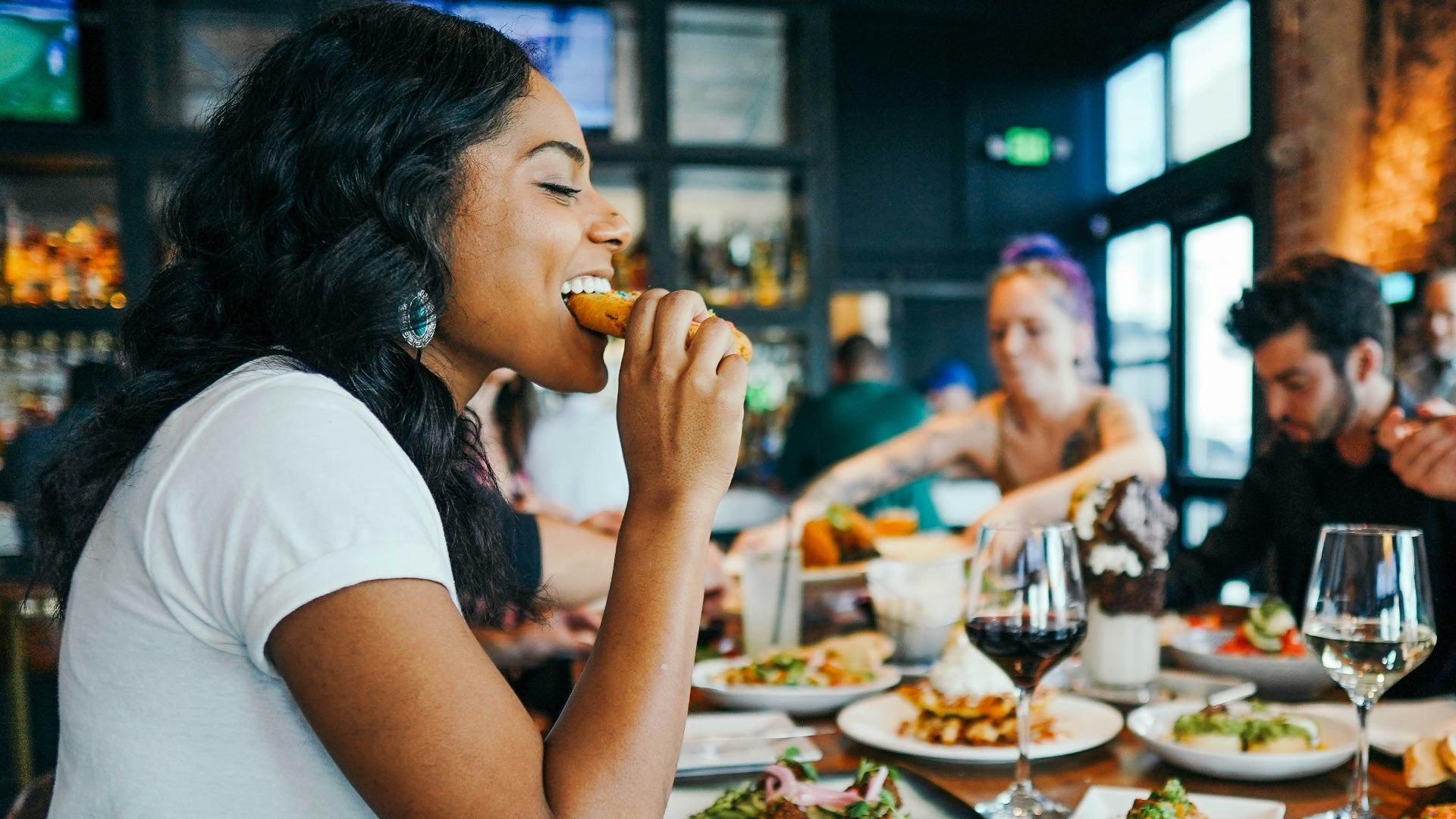 woman in white shirt eating