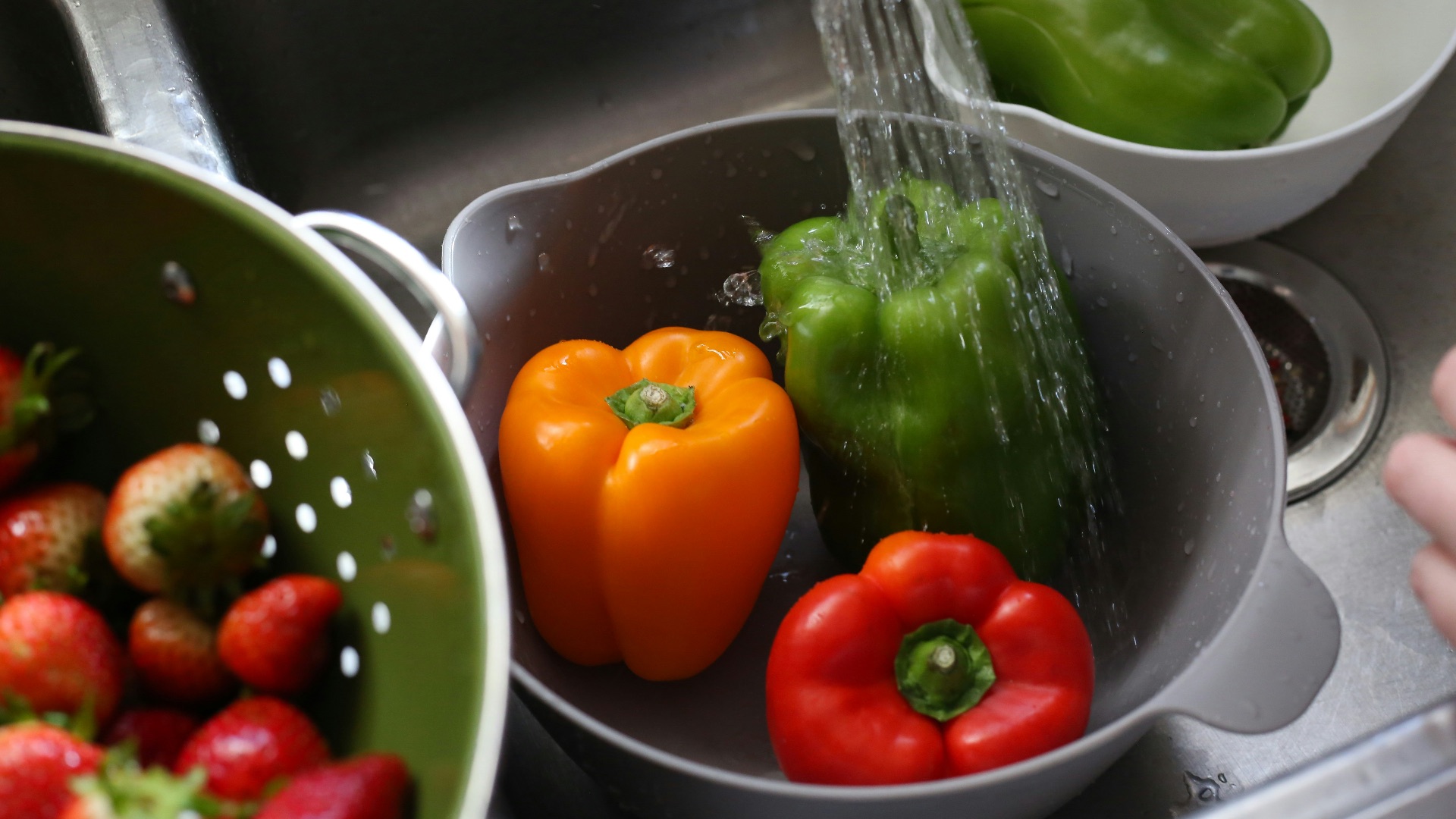 a sink filled with lots of different types of vegetables