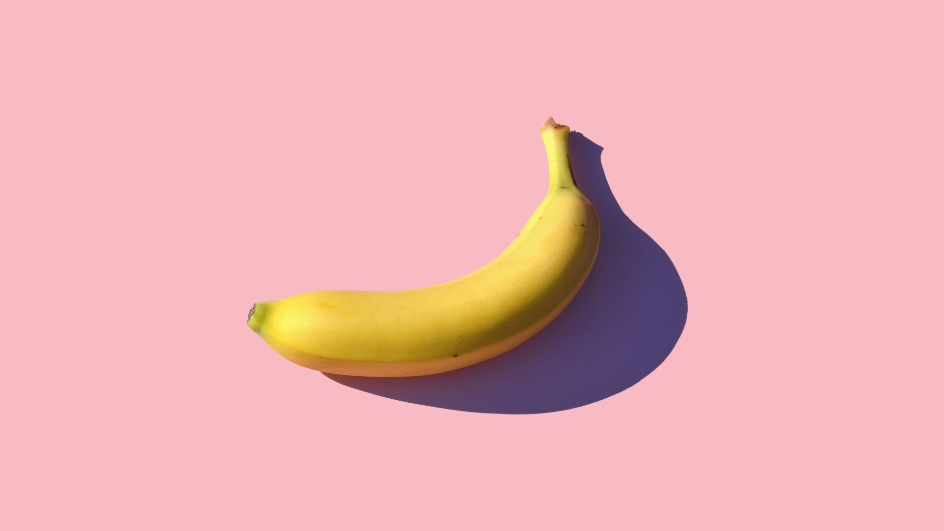 riped banana on pink surface