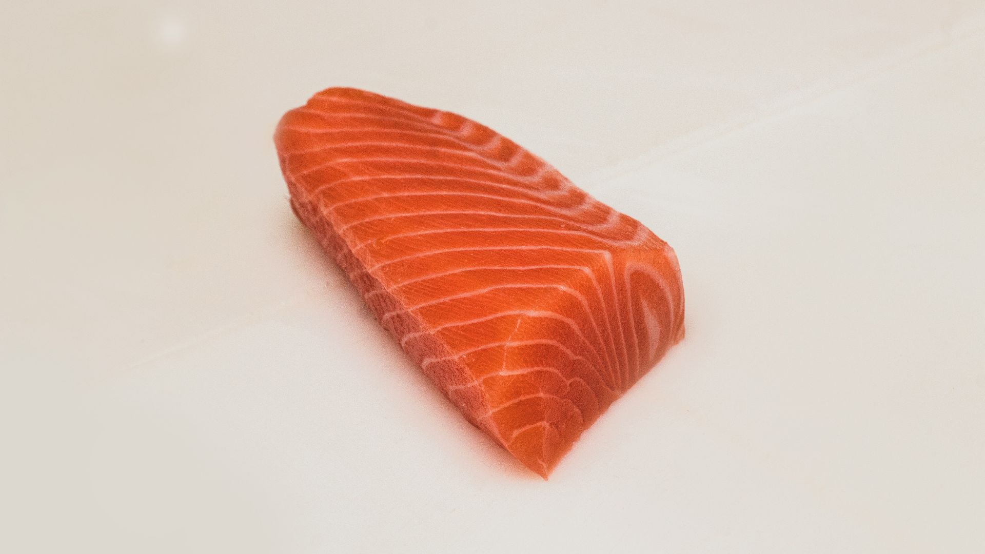 sliced fish meat on white surface