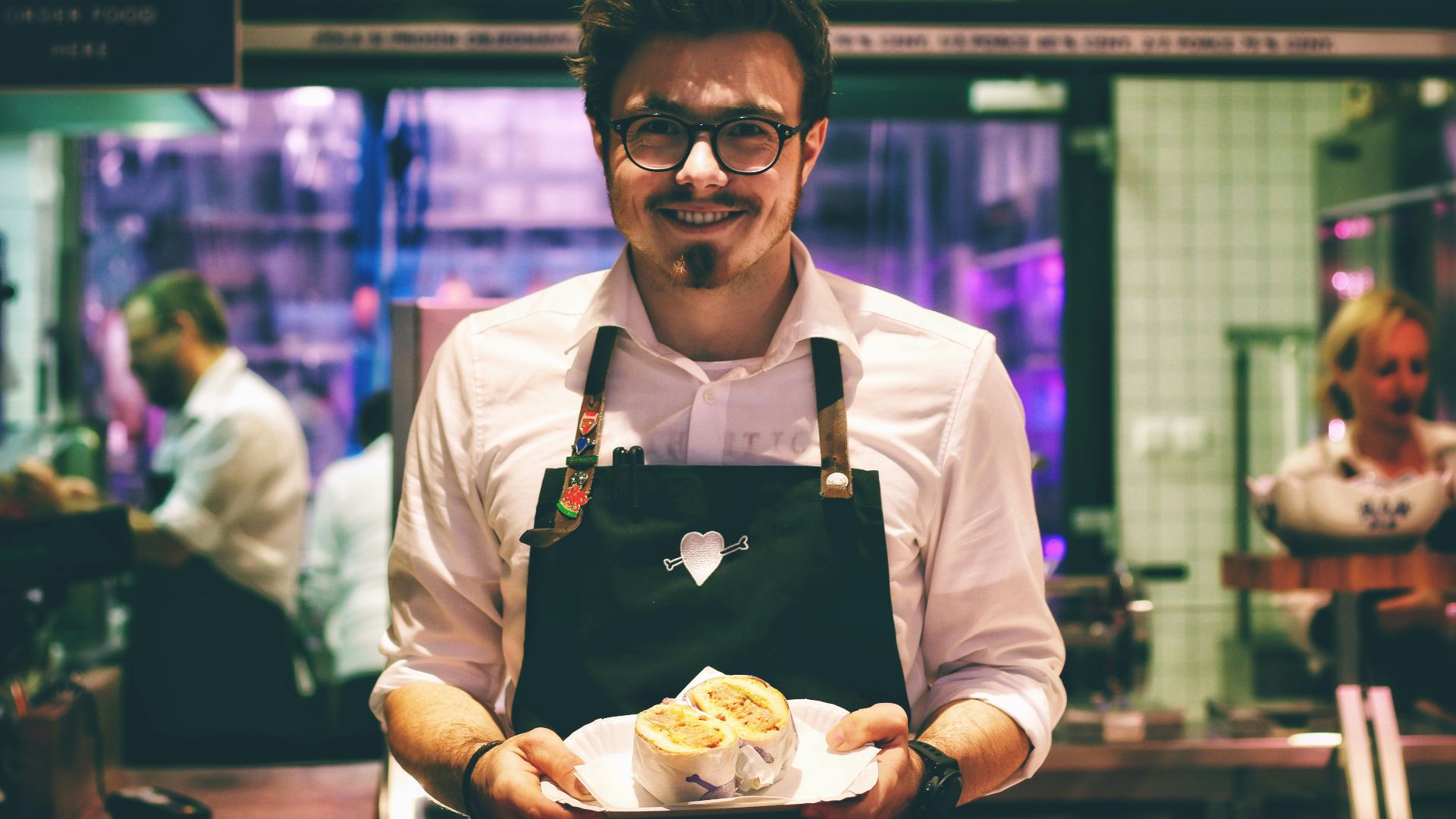 man holding fish dish on plate
