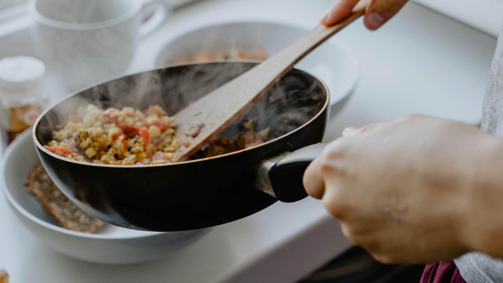 person holding black frying pan