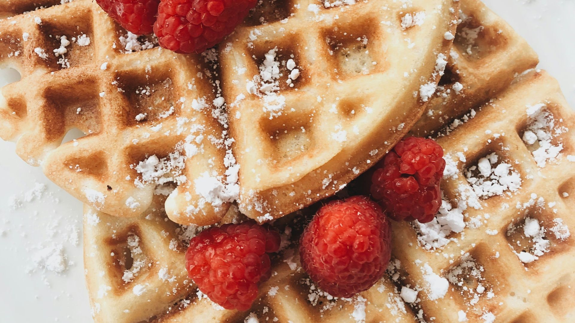 red strawberries on brown waffles