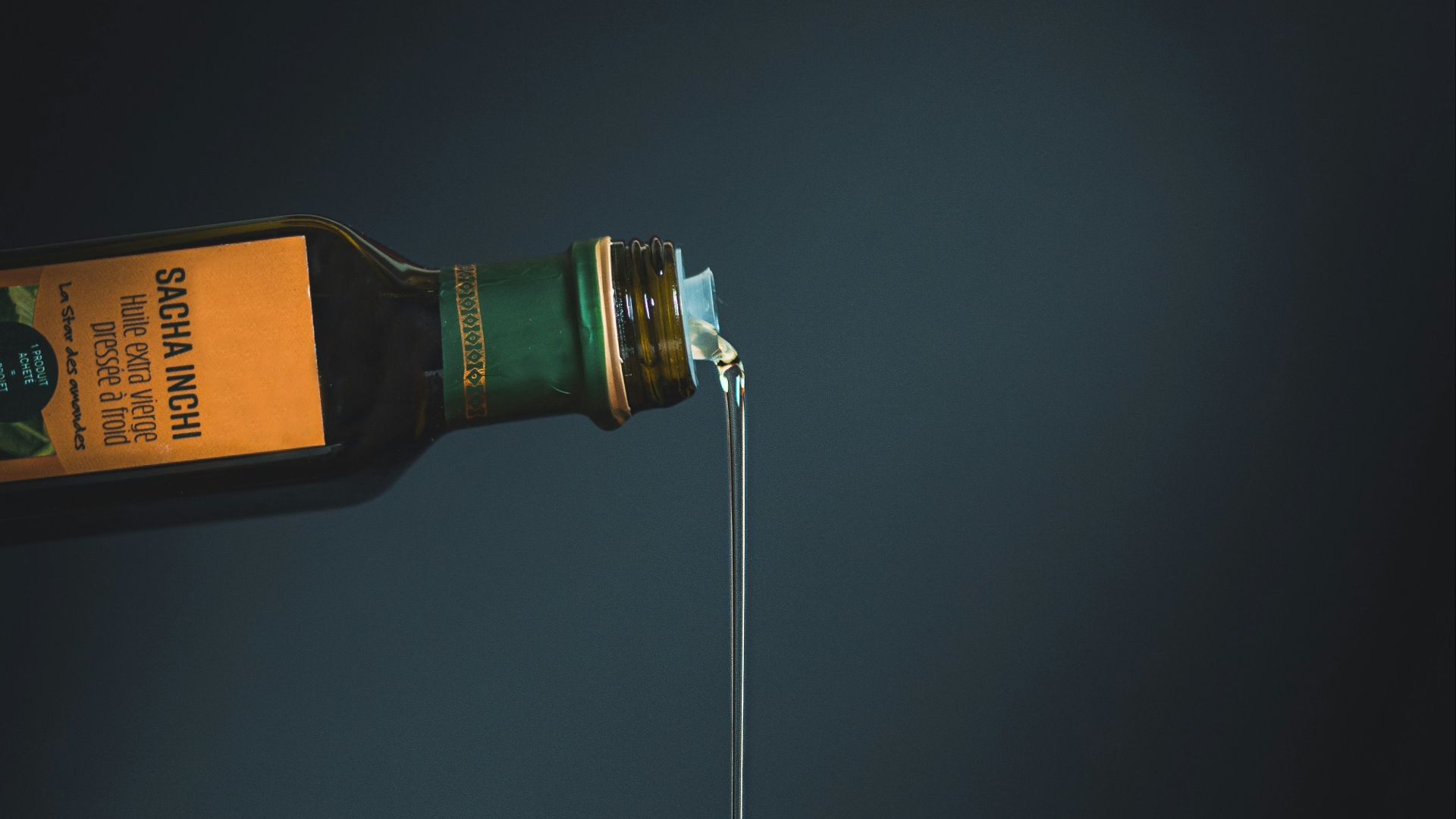 bottle with white liquid pouring through the brown slab