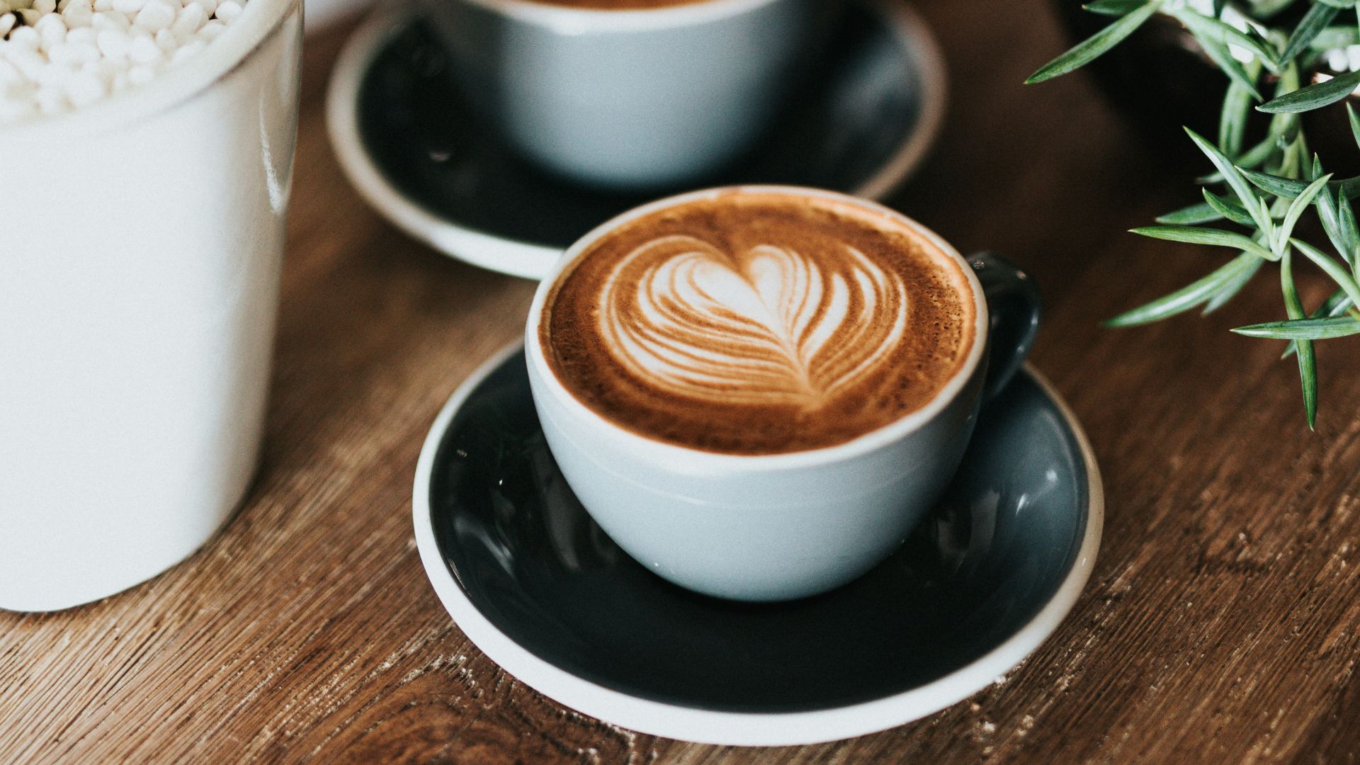 shallow focus photography of coffee late in mug on table