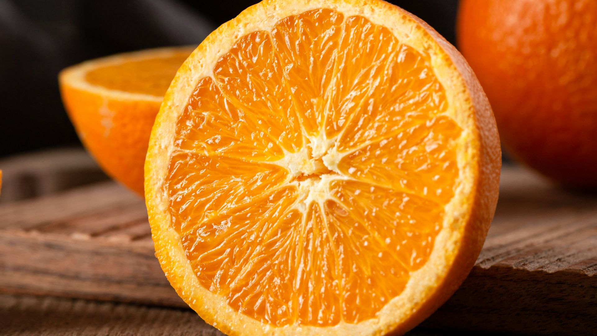 sliced orange fruit on brown wooden table