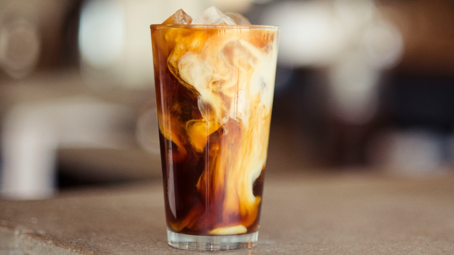 glass cup filled with ice latte on tabletop