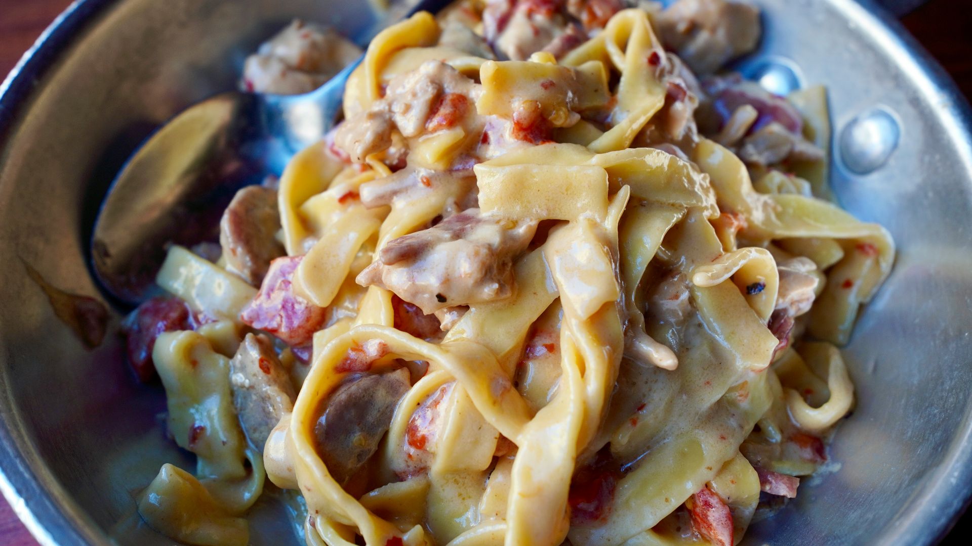 A plate of pasta with meat and vegetables