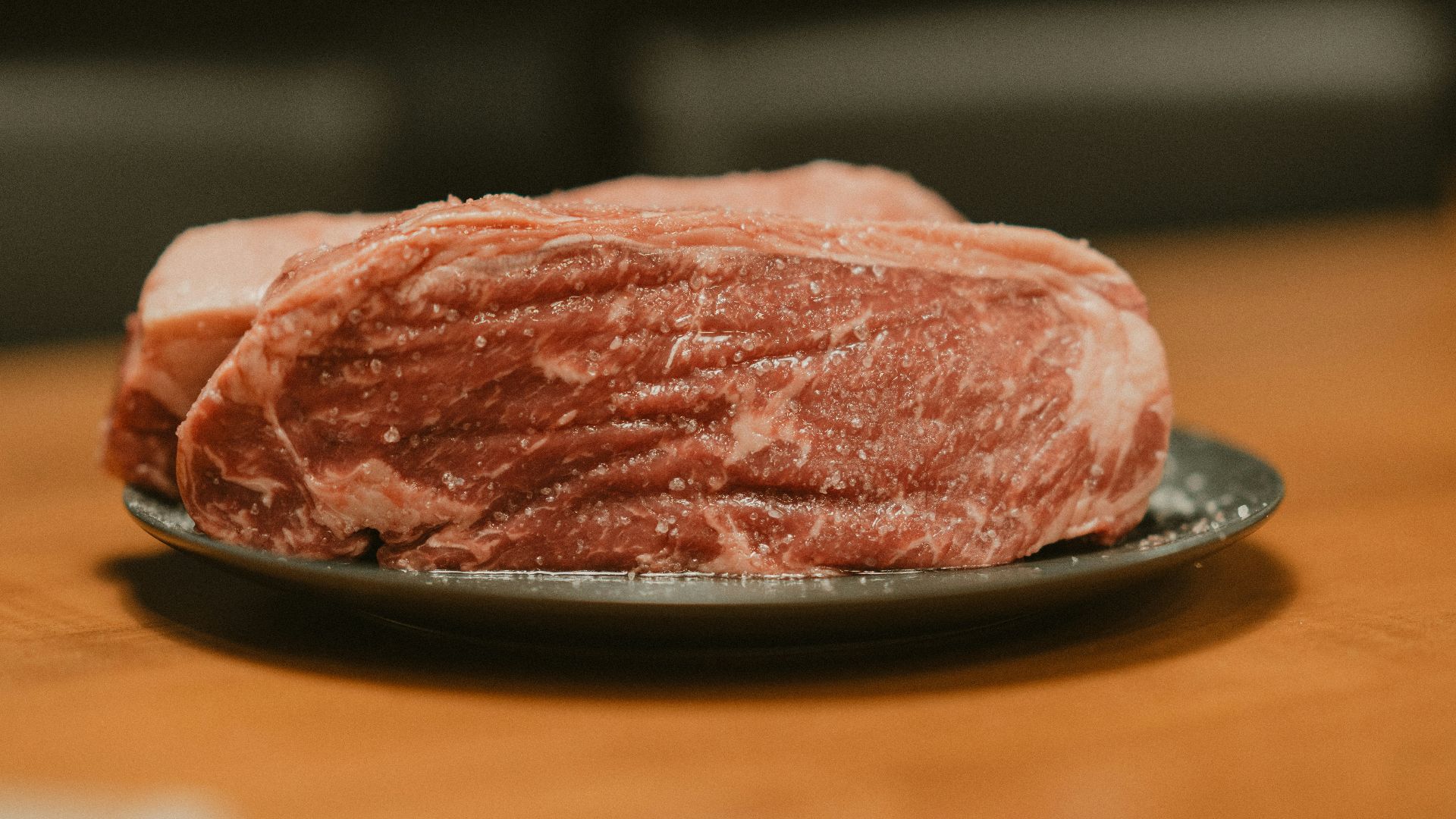 A piece of meat on a plate on a table