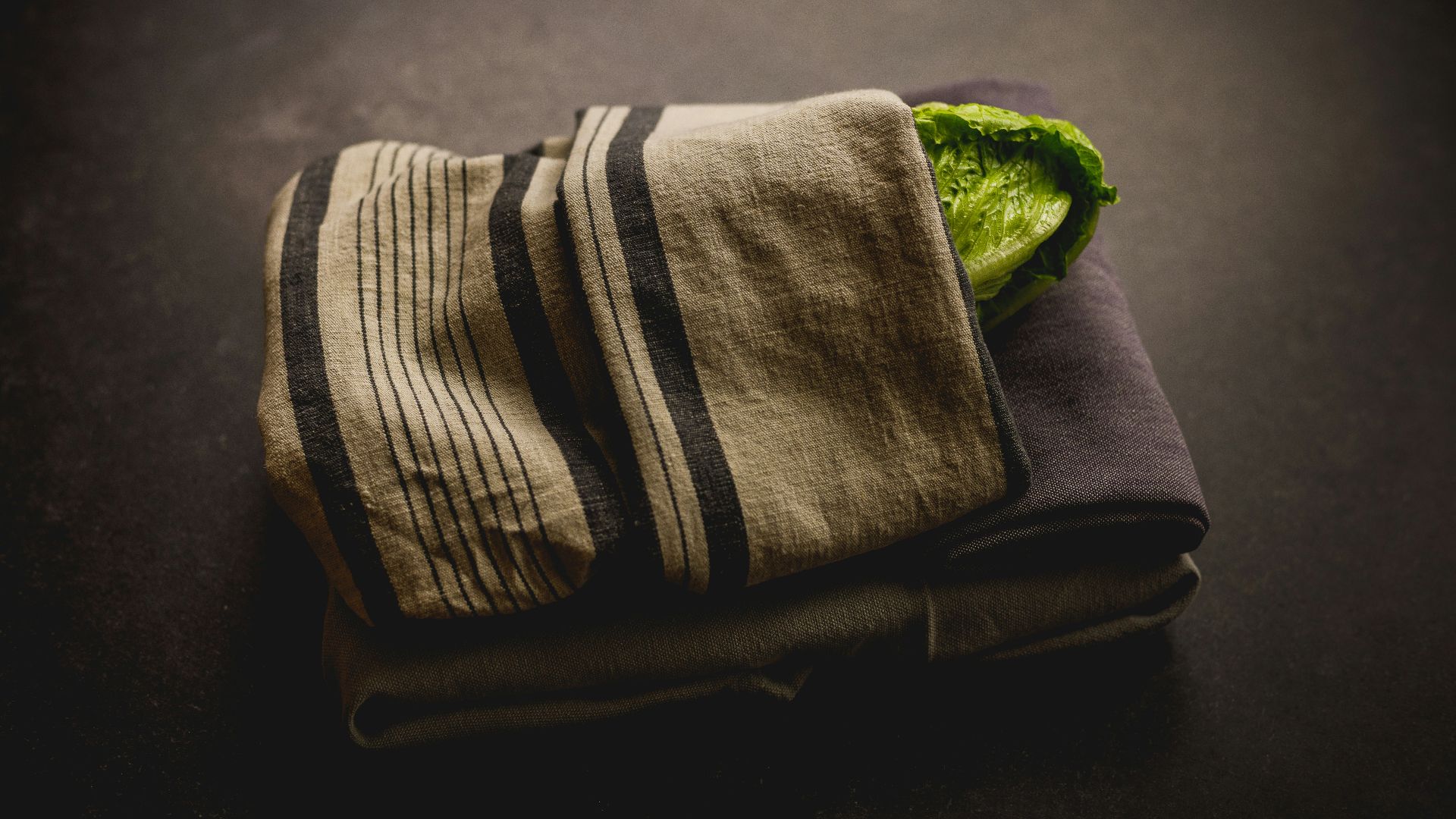 a towel with a green leaf on top of it