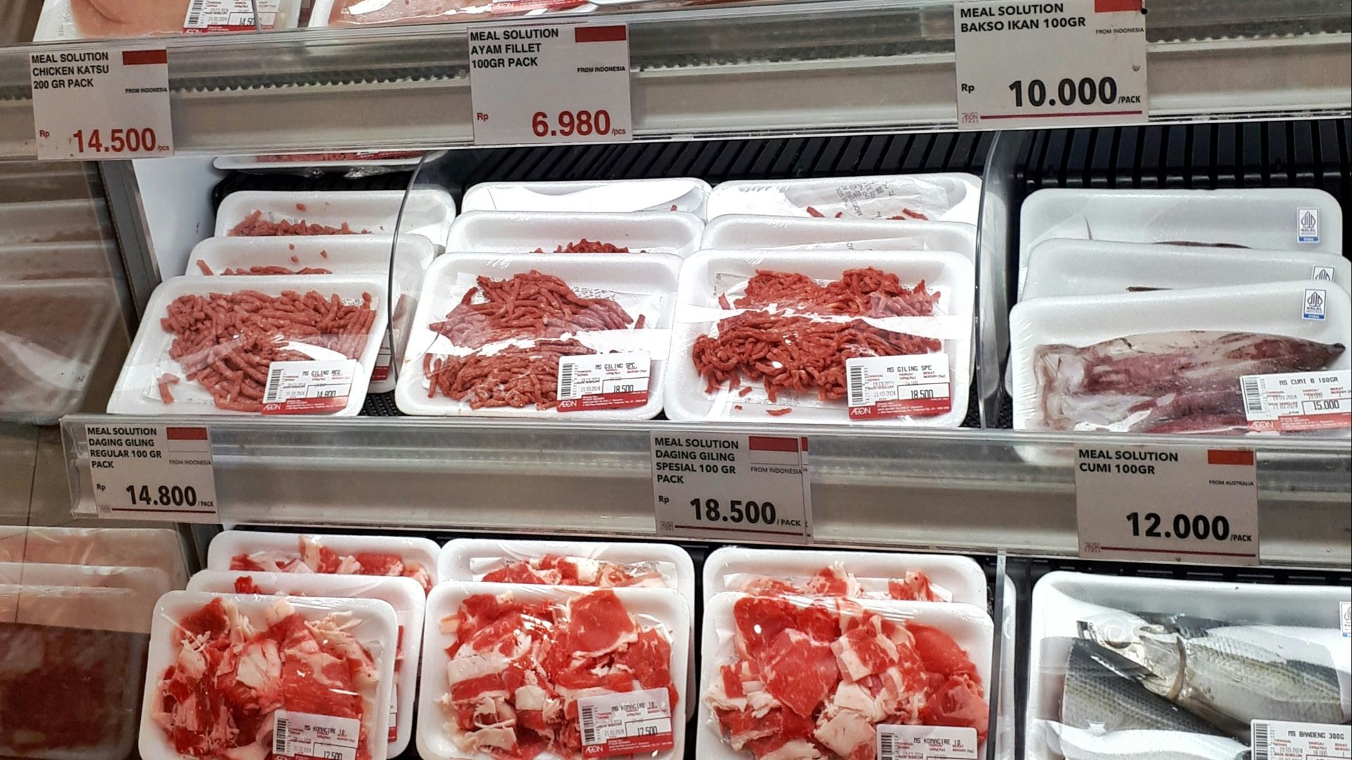 A display case filled with lots of different types of meat