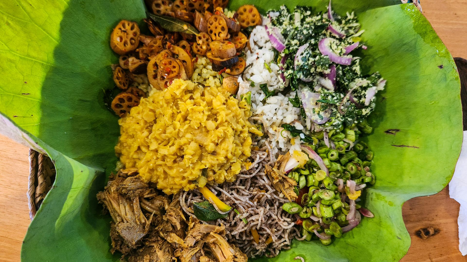 A sri lankan meal is presented on a leaf.