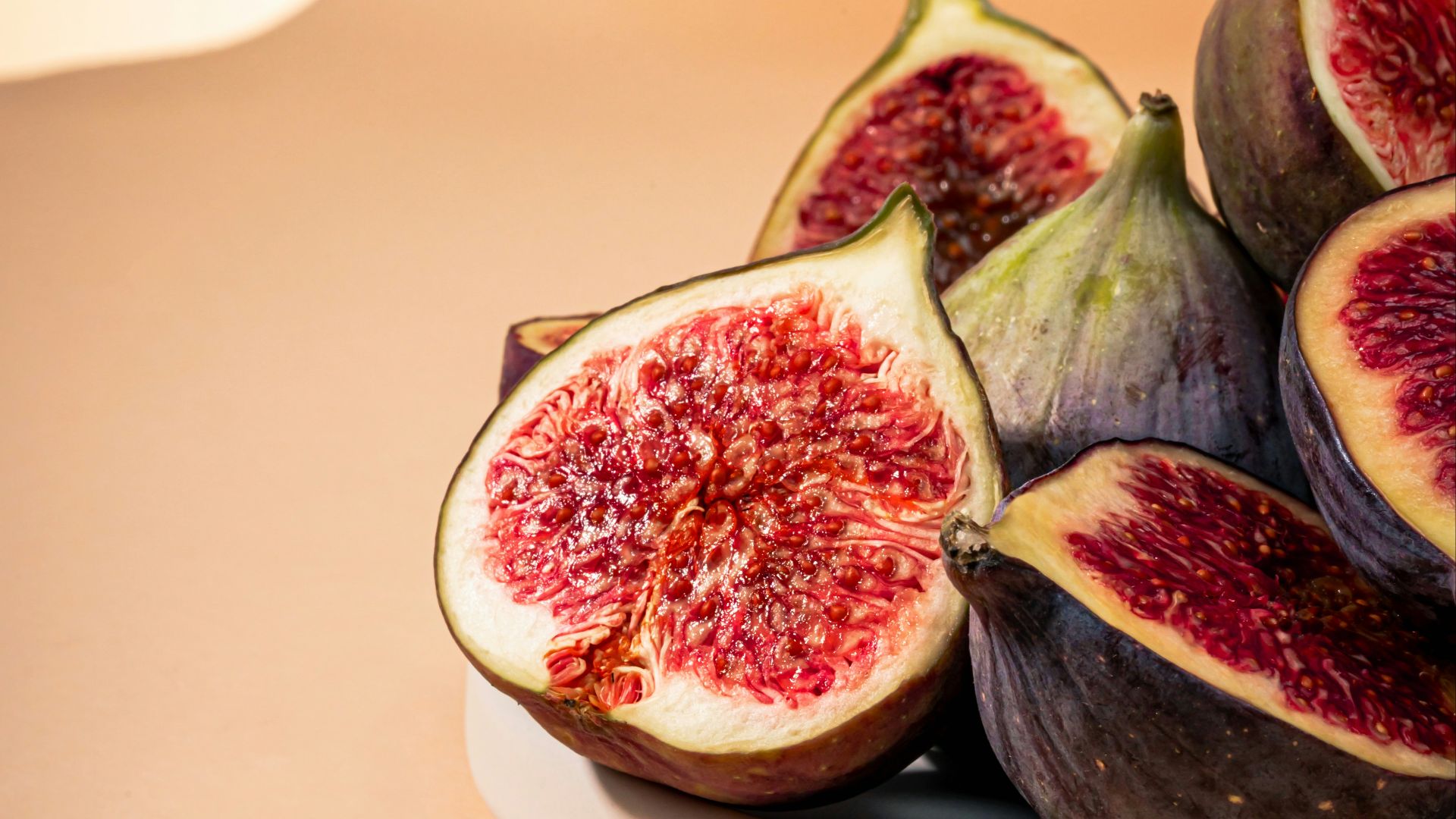 a white plate topped with sliced figs on top of a table