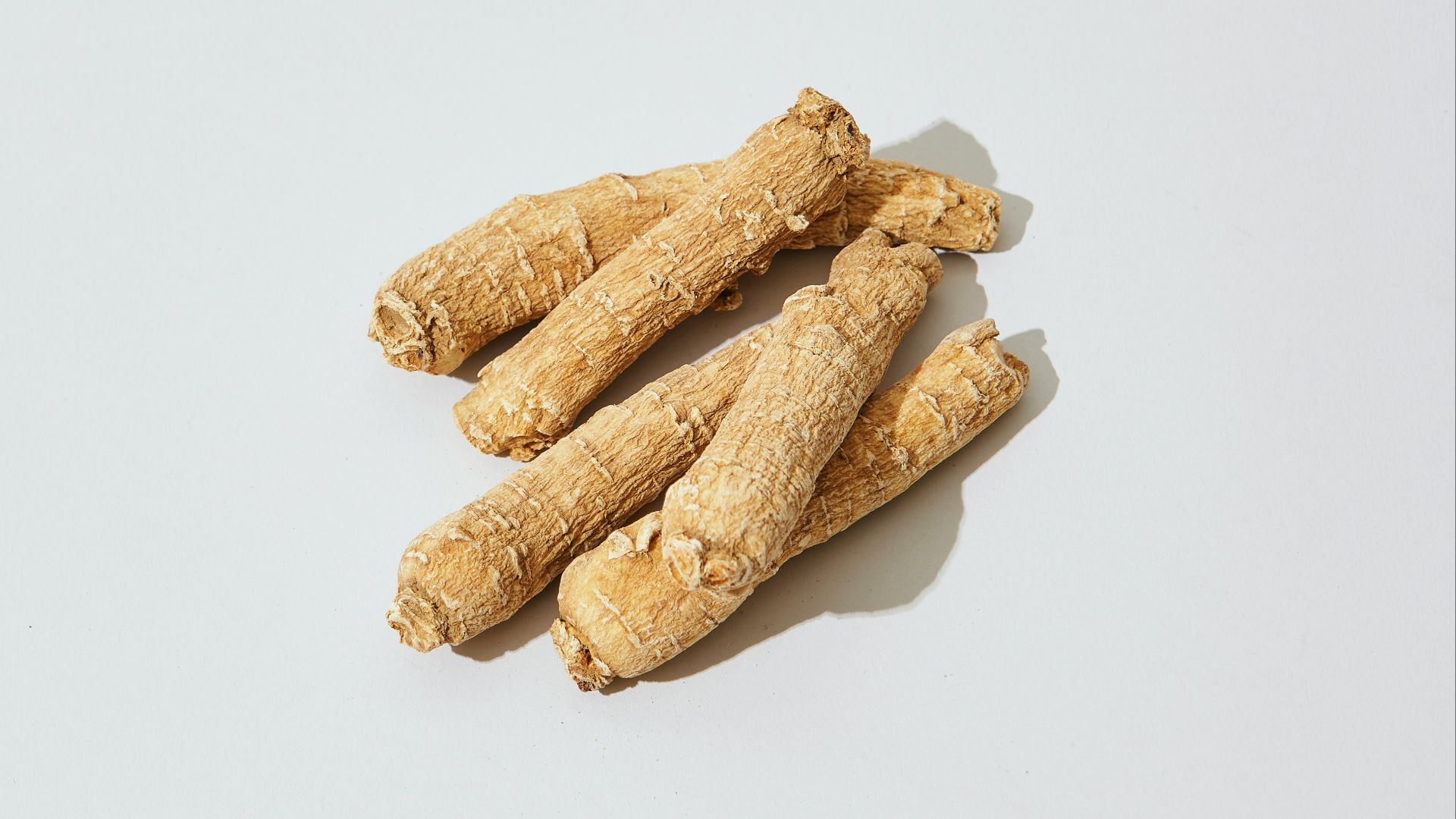 three pieces of ginger on a white surface