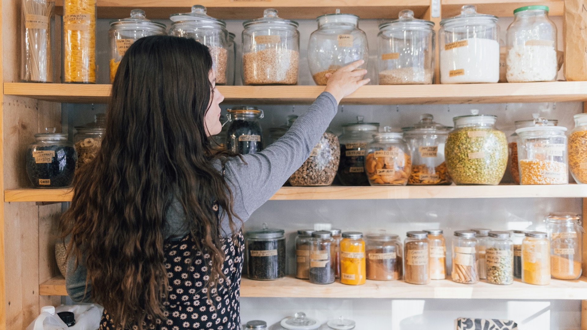 a person holding a jar of food