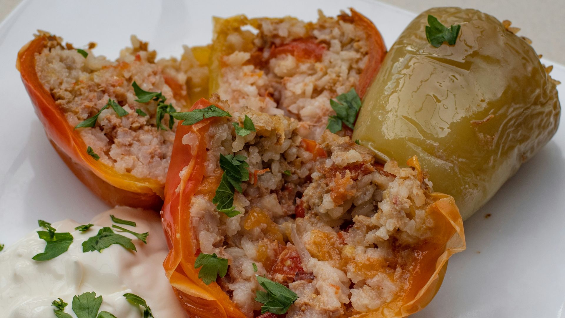a white plate topped with stuffed bell peppers