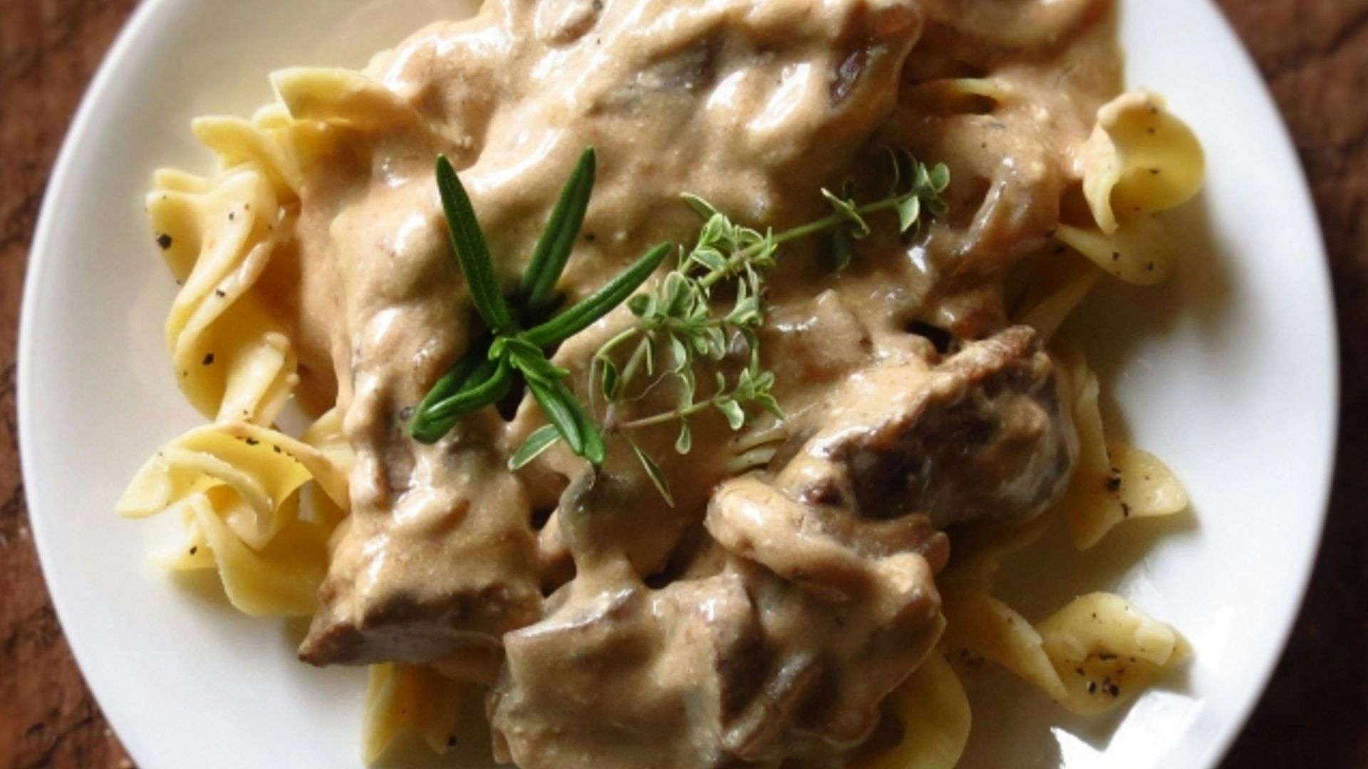 a white plate topped with pasta covered in sauce